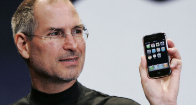 FILE- In this Jan. 9, 2007, file photo, Apple CEO Steve Jobs holds up an iPhone at the MacWorld Conference in San Francisco. Jobs introduced the first iPhone a decade ago. Jobs' "magical product" reshaped culture, shook up industries and made it seem possible to do just about anything with a few taps on a screen while walking around with the equivalent of a computer in our pocket. (AP Photo/Paul Sakuma, File)